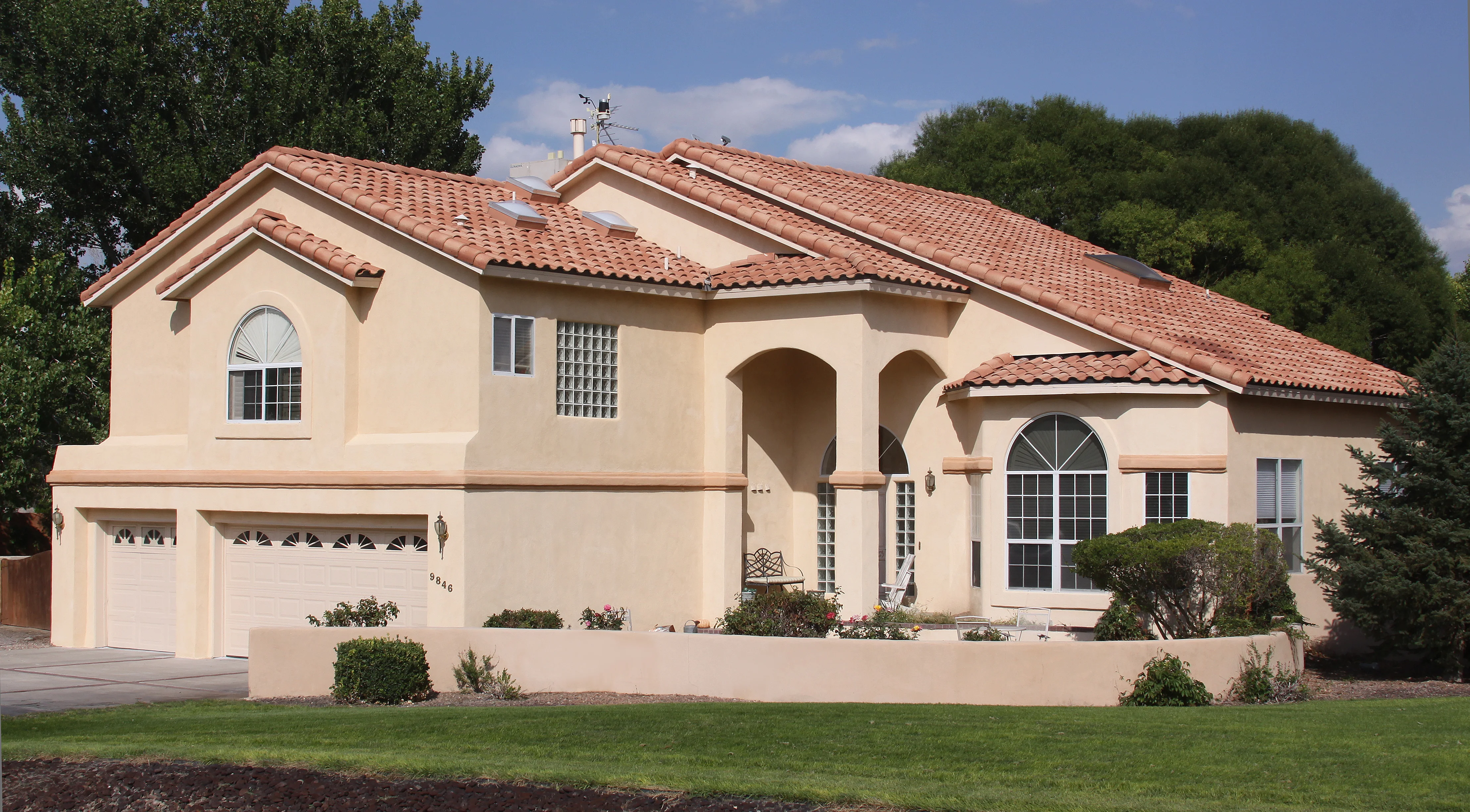 A residence with a substantial garage and a wide driveway, emphasizing ample space for vehicles and outdoor activities.